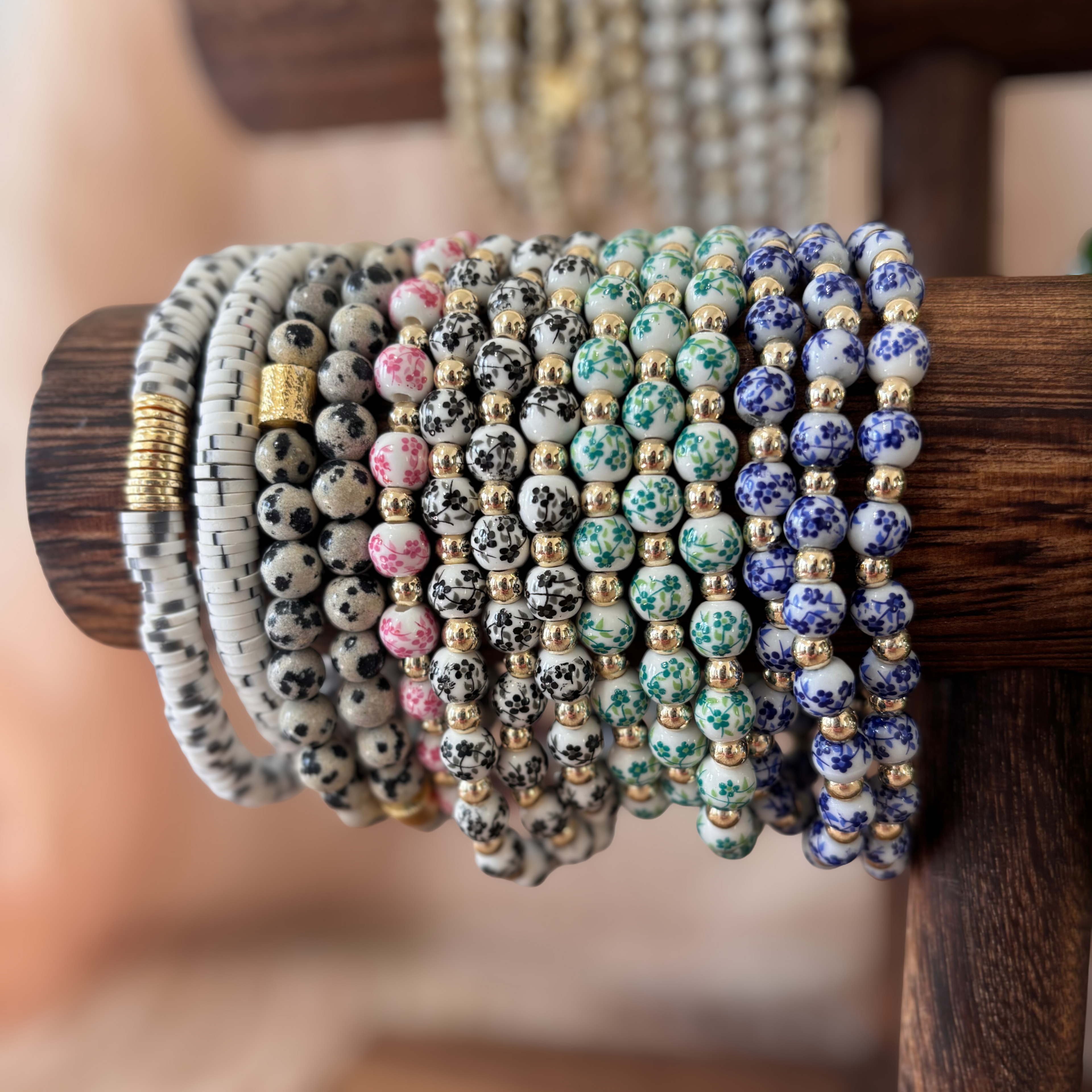 Collection of beaded bracelets on a wooden holder